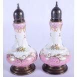 A PAIR OF SILVER MOUNTED PORCELAIN CONDIMENTS. 15 cm high.