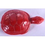 A CHINESE CARVED RED CORAL TORTOISE, formed with its head raised. 4.5 cm wide.