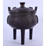 A CHINESE BRONZE TRI LEGGED CENSER, decorated with taotie mask heads. 18 cm x 12.5 cm.