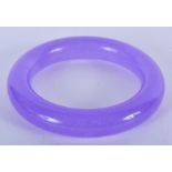 A CHINESE PURPLE JADE BANGLE. 8.5 cm wide.