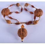 A VINTAGE MIDDLE EASTERN ASIAN CARVED NUT AND HORN NECKLACE. 80 cm long.