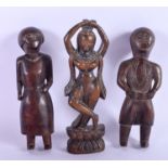 A PAIR OF WEST AFRICAN CARVED WOODEN FIGURES, together with a Himalayan dancer. 20 cm. (3)
