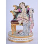 EARLY19TH C. DERBY FIGURE OF A GIRL SEATED IN A CHAIR. 12cm high and 9cm wide.