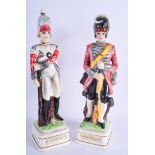 A PAIR OF NOVELTY SOLIDER DECANTERS. 37 cm high.