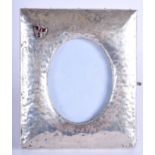 AN ARTS AND CRAFTS HAMMERED SILVER JEWELLED PHOTOGRAPH FRAME. 16 cm x 12 cm.