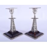 A PAIR OF VICTORIAN SILVER AND TORTOISESHELL CANDLESTICKS. London 1897. 15 cm high.