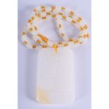A CHINESE CARVED JADE PENDANT TABLET NECKLACE. 4.5 cm x 6.25 cm.