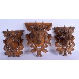 THREE 19TH CENTURY BAVARIAN BLACK FOREST CARVED DEER HEAD WALL PLAQUES modelled within foliate mount