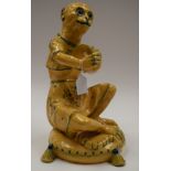 A LARGE EARLY 20TH CENTURY CONTINENTAL YELLOW GLAZED FAIENCE MONKEY modeled playing a tambourine. 40