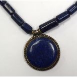 AN EARLY 20TH CENTURY CARVED LAPIS LAZULI NECKLACE, formed with sectional cylindrical beads. 56 cm l