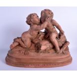 A LARGE 19TH CENTURY FRENCH TERRACOTTA FIGURE OF A BOY AND GIRL modelled upon a naturalistic base. 3