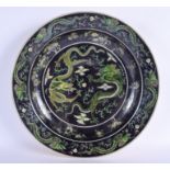 A 19TH CENTURY CHINESE FAMILLE NOIRE CIRCULAR CHARGER Qing, Kangxi style, painted with dragons pursu