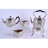 AN ANTIQUE FOUR PIECE SILVER PLATED TEASET decorated with scrolling foliage and vines. Largest 32 cm