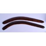 A PAIR OF VINTAGE AUSTRALIAN CARVED WOOD ABORIGINAL BOOMERANG. 68 cm long.