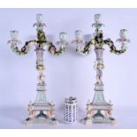 A LARGE PAIR OF 19TH CENTURY GERMAN TRIPLE BRANCH CANDLEABRA formed with figures holding aloft flora