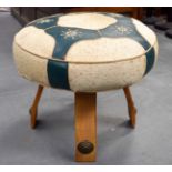 A VINTAGE HIDE MOUNTED BUGATTI INSPIRED STOOL with brass roundels. 48 cm x 50 cm.