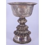 A 19TH CENTURY CHINESE TIBETAN SILVER LIBATION CUP of foliate form. 226 grams. 13.5 cm high.