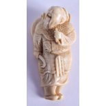 AN 18TH CENTURY JAPANESE EDO PERIOD CARVED IVORY NETSUKE modelled as a bearded male holding a scythe