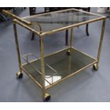 A 1950S FRENCH BRASS FAUX BAMBOO AND SMOKEY GLASS DRINKS TROLLEY. 69 cm x 78 cm.