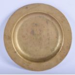 A CHINESE QING DYNASTY BRONZE CIRCULAR DISH decorated with archaic script. 23.5 cm diameter.