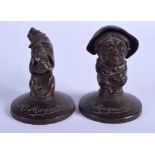 A PAIR OF 1920S MAY AND PADMORE CAR MASCOTS depicting Mr and Mrs Maymore. 9 cm x 5 cm.