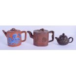 THREE EARLY 20TH CENTURY CHINESE YIXING POTTERY TEAPOTS AND COVERS Qing. Largest 18 cm wide. (3)