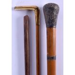 A 19TH CENTURY CONTINENTAL WHITE METAL AND MALACCA WALKING CANE together with two others. Largest 90