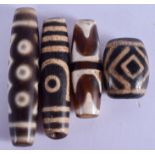FOUR CHINESE TIBETAN AGATE ZHU BEADS. Largest 6.25 cm wide. (4)
