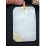 A CHINESE CARVED JADE PENDANT TABLET NECKLACE. 4.5 cm x 6.25 cm.