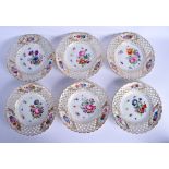 A SET OF SIX 19TH CENTURY MEISSEN RETICULATED PORCELAIN PLATES painted with flowers. 23.5 cm wide. (