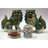 A PAIR OF CHINESE BUDDHISTIC LIONS together with a cup and saucer etc. (4)