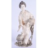 A FINE 19TH CENTURY JAPANESE MEIJI PERIOD CARVED IVORY OKIMONO modelled holding fowl and trailing vi