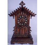 A LARGE ANTIQUE BAVARIAN BLACK FOREST TRUMPET MAN CUCKOO CLOCK modelled in the gothic style. 62 cm x
