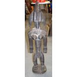 A LARGE MALIAN BAMBARA WOODEN STATUE, formed standing with copper piercings and studwork to head. 87