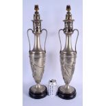 A PAIR OF 19TH CENTURY SILVER PLATED CLASSICAL OIL LAMPS with handles to either side, the bodies dec