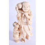 A 19TH CENTURY JAPANESE MEIJI PERIOD CARVED IVORY OKIMONO modelled as a male holding a monkey. 8.5 c