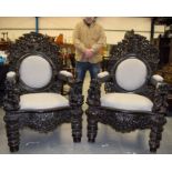 A VERY RARE PAIR OF 19TH CENTURY CHINESE HONGMU THRONE ARM CHAIRS Qing, carved with figures, dragons