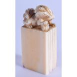 A 19TH CENTURY CHINESE CARVED IVORY SEAL Qing, formed with a recumbent hound. 4.5 cm x 3.5 cm.