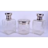 A SET OF THREE EDWARDIAN NEO CLASSICAL SILVER TOPPED BOTTLES. London 1916. Largest 16.5 cm high. (3)