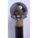 AN ANTIQUE CARVED AGATE HANDLED WALKING CANE. 98 cm long.