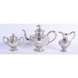 A 19TH CENTURY CHINESE EXPORT SILVER THREE PIECE TEASET by Woshing, decorated with dragons amongst c