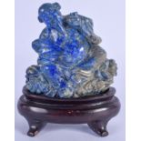 AN EARLY 20TH CENTURY CHINESE CARVED LAPIS LAZULI BUDDHISTIC DEITY modelled holding a fan. Lapis 8 c