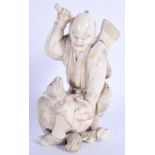 A 19TH CENTURY JAPANESE MEIJI PERIOD CARVED IVORY OKIMONO modelled as a male holding aloft an axe. 1