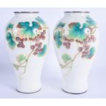 A PAIR OF EARLY 20TH CENTURY JAPANESE PLIQUE A JOUR ENAMEL VASES decorated with berries and foliage.