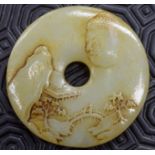 A CHINESE JADE ROUNDEL. 6.25 cm wide.