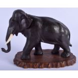 A 19TH CENTURY JAPANESE MEIJI PERIOD BRONZE OKIMONO modelled as a roaming elephant. 30 cm x 22 cm.