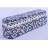 AN UNUSUAL TURKISH KUTAHYA FAIENCE IZNIK PEN BOX AND COVER painted with foliage. 26 cm wide.