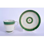 AN 18TH CENTURY WORCESTER COFFEE CUP AND SAUCER of ribbed form, upon apple green border. Saucer 13 c