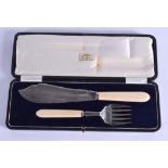 AN ART DECO SILVER AND IVORY CASED FORK AND KNIFE. 30 cm long.