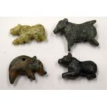 FOUR CENTRAL ASIAN STONE AMULETS. (4)